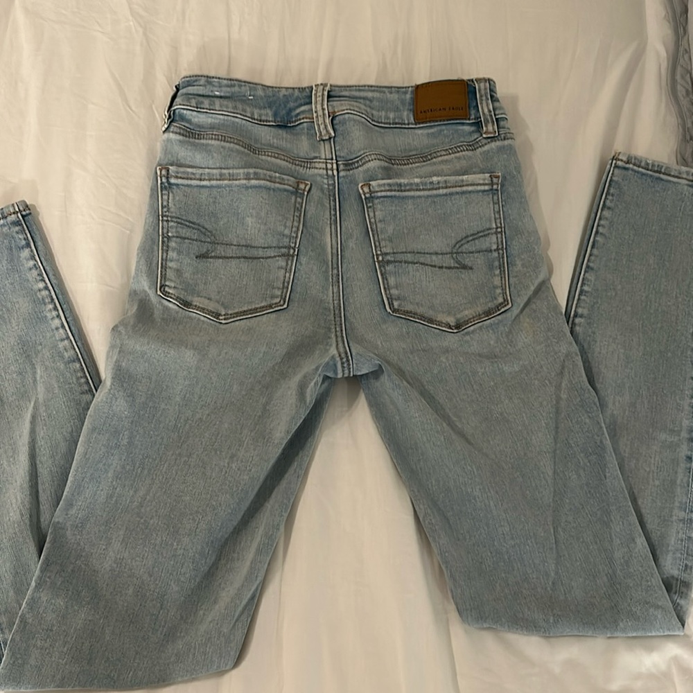 American Eagle denim skinny jeans, partial distress on the pockets, light wash!